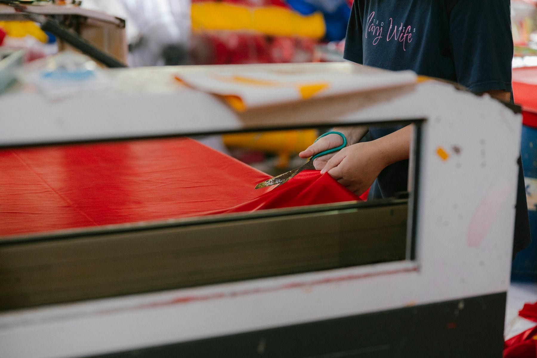 Layered fabric being cut to pattern on a cutting table