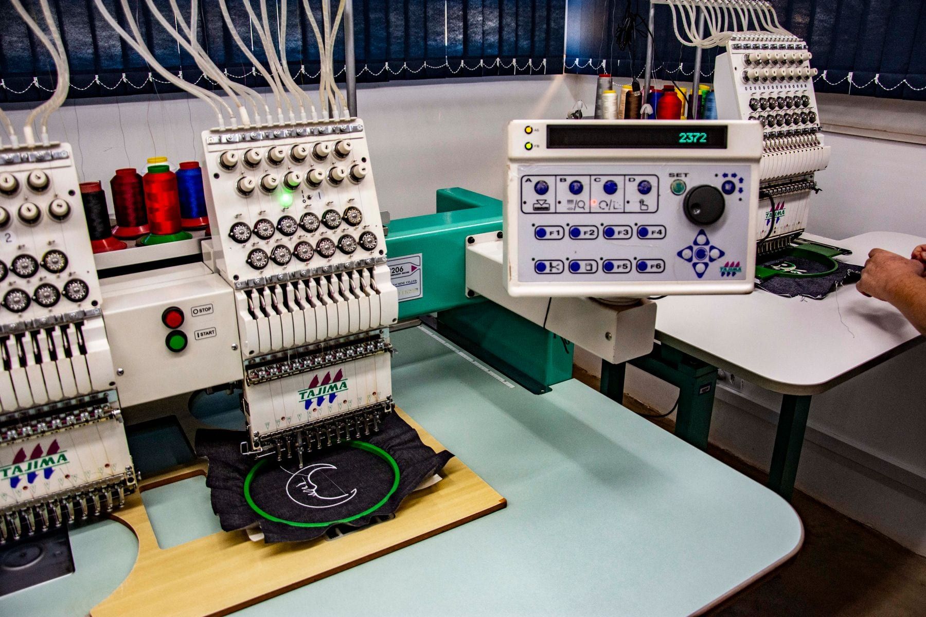 Embroidery machine stitching a logo onto a garment