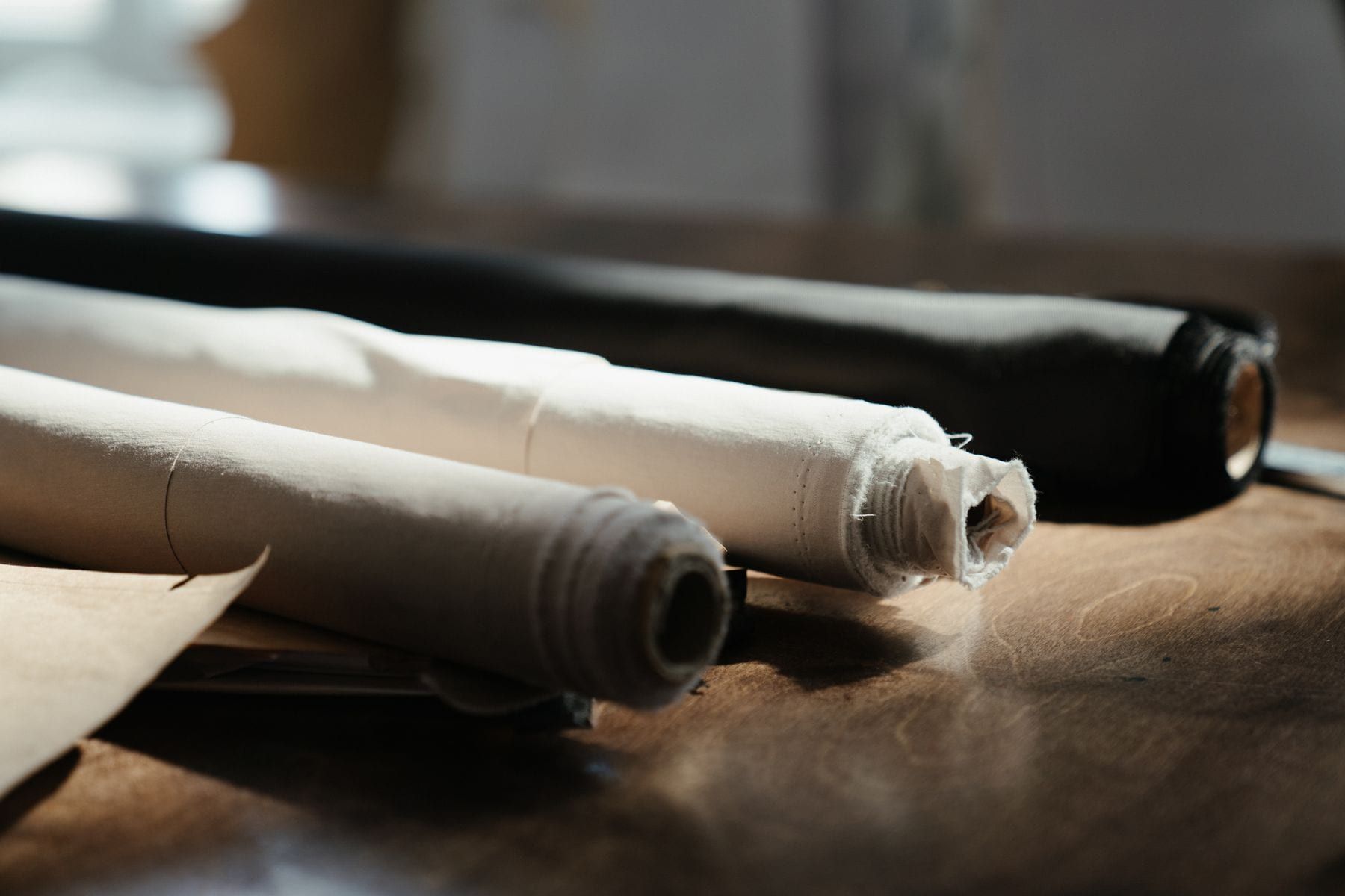 Rolls of uniform fabric on an inspection table