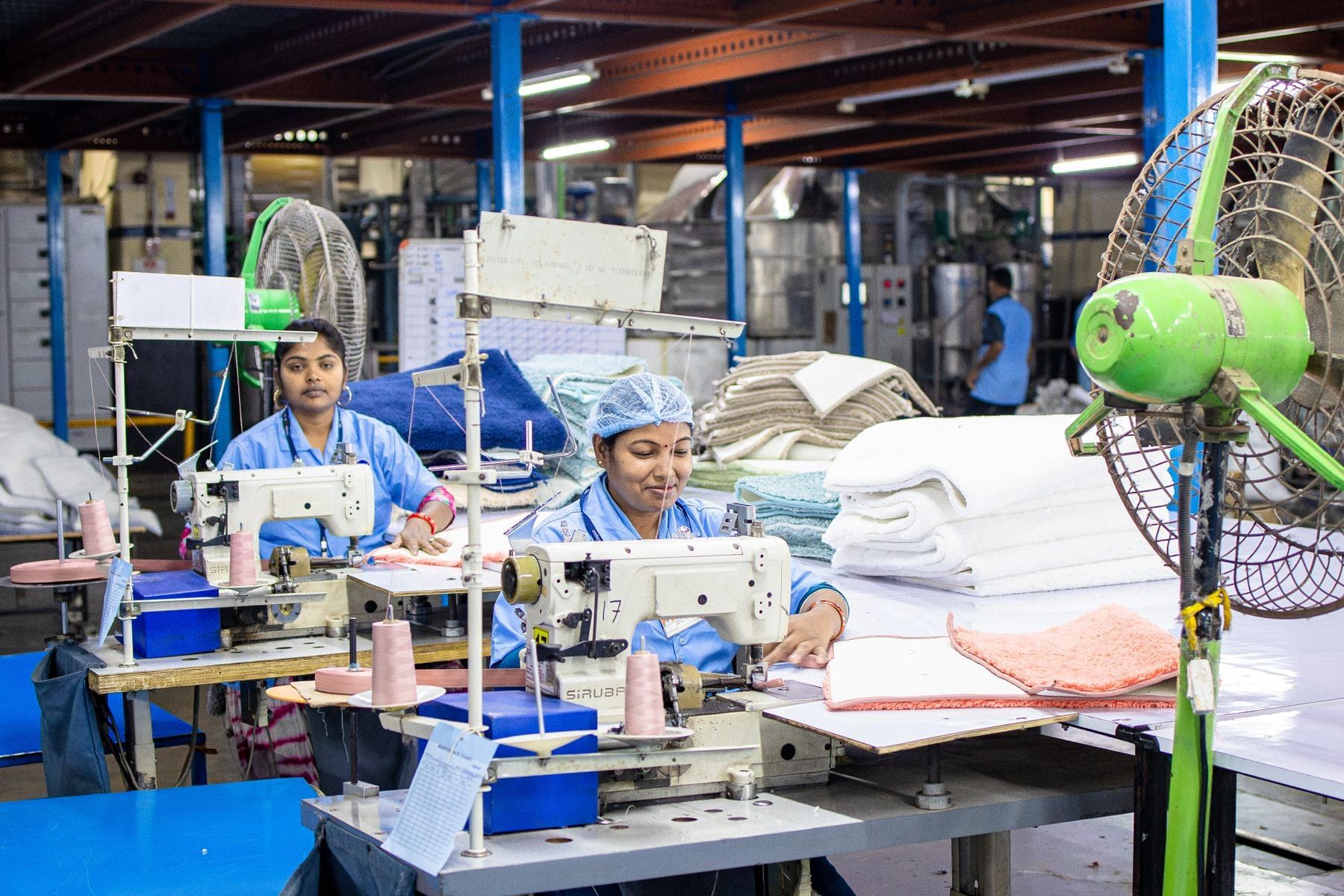 Operator sewing a shirt on an industrial sewing machine