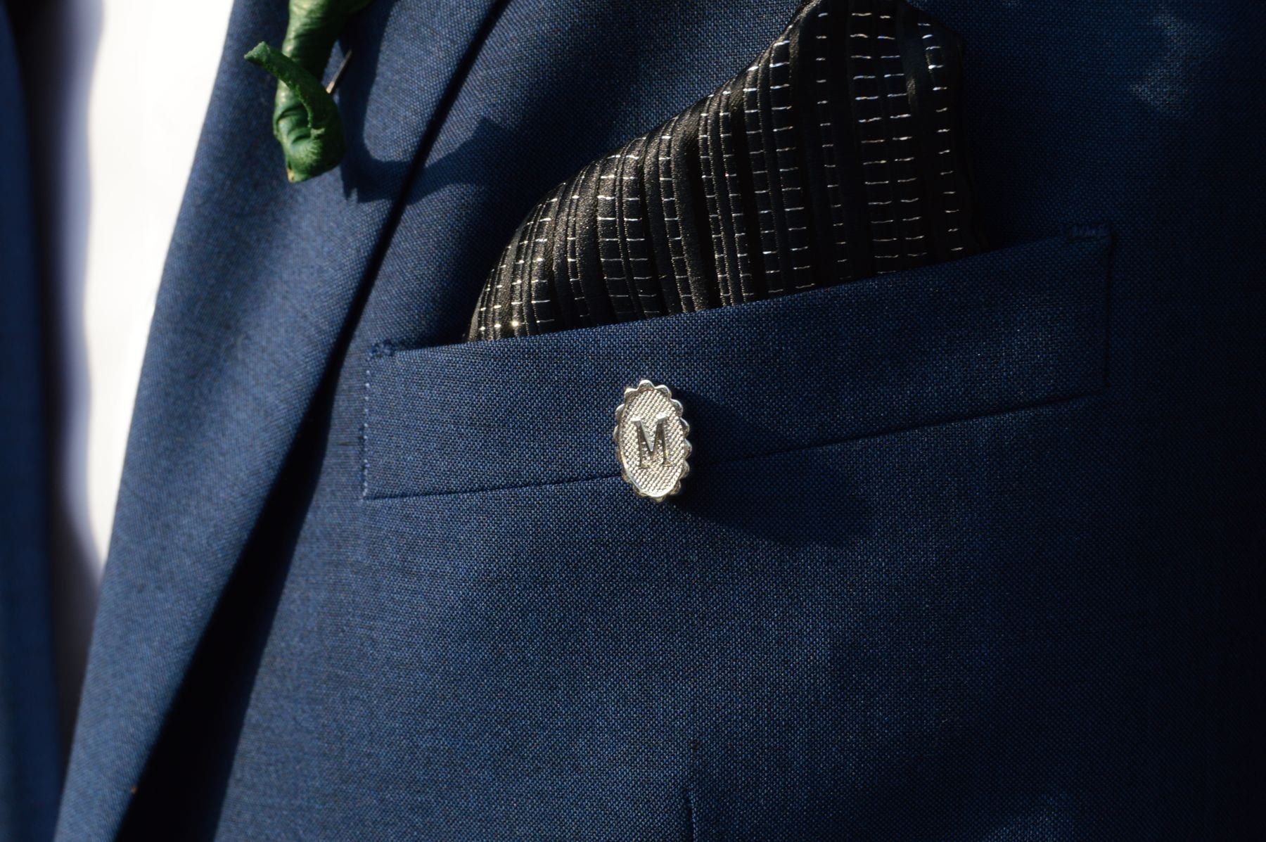 Charcoal gabardine suiting fabric folded to show its smooth diagonal face