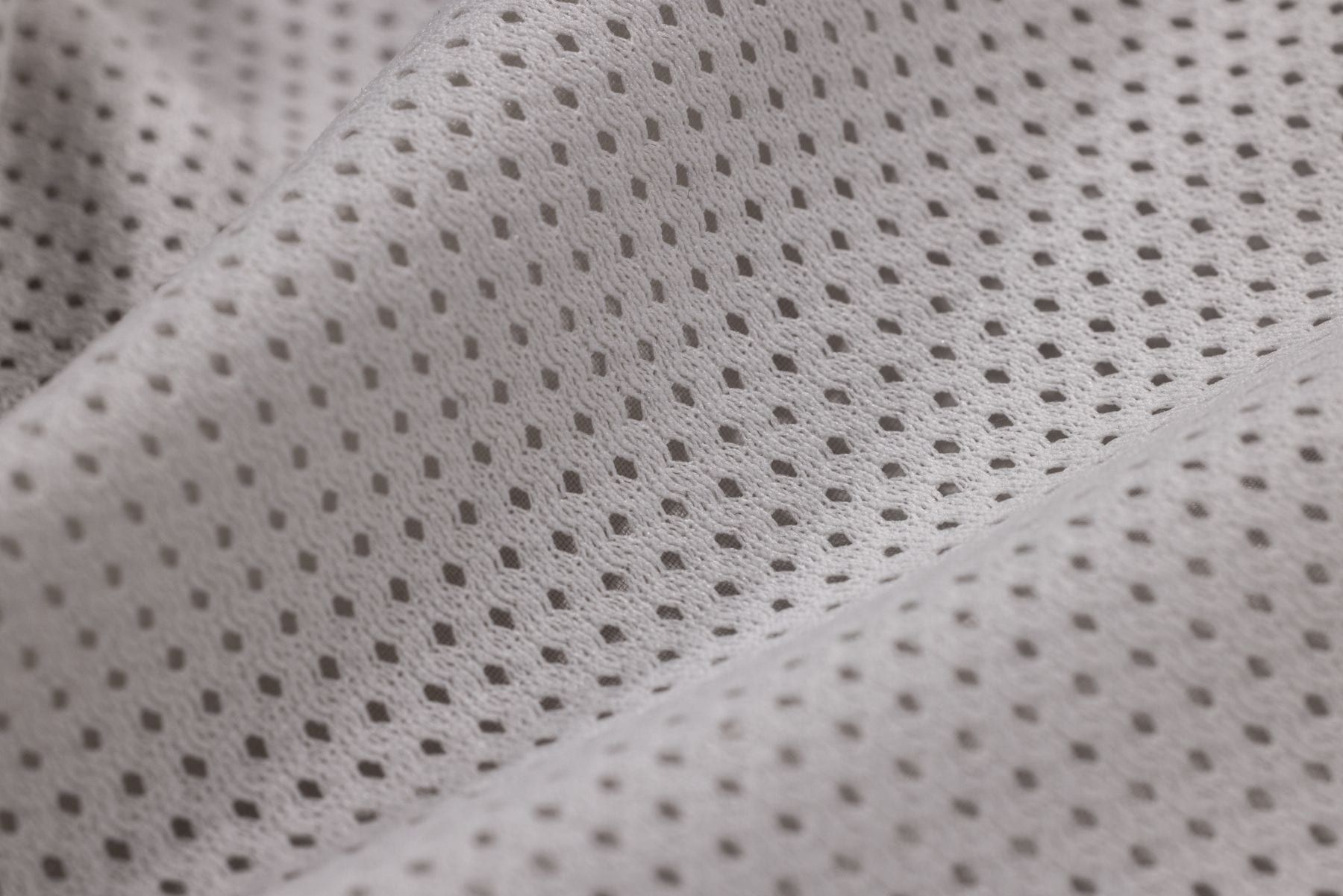 White poplin shirting fabric folded to show its smooth surface