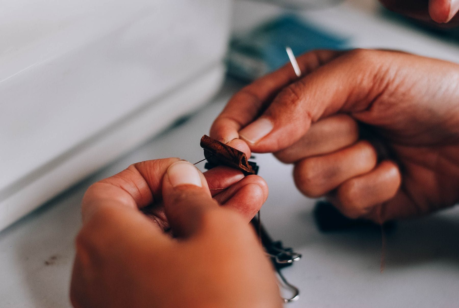 Inspector measuring a folded polo shirt against a size chart